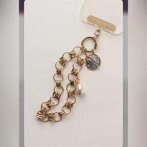 Free People gold color Charmed phone wristlet